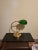 This is a tall and elegant vintage banker’s lamp with the classic green glass shade. The brass base makes it a timeless...