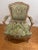 Pair of French Louis XV-style bergère armchairs featuring beautifully carved beechwood frames with a softly distressed...