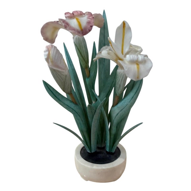 Intricately carved Asian floral sculpture depicting a delicate iris arrangement. Pink and white irises carved from a...