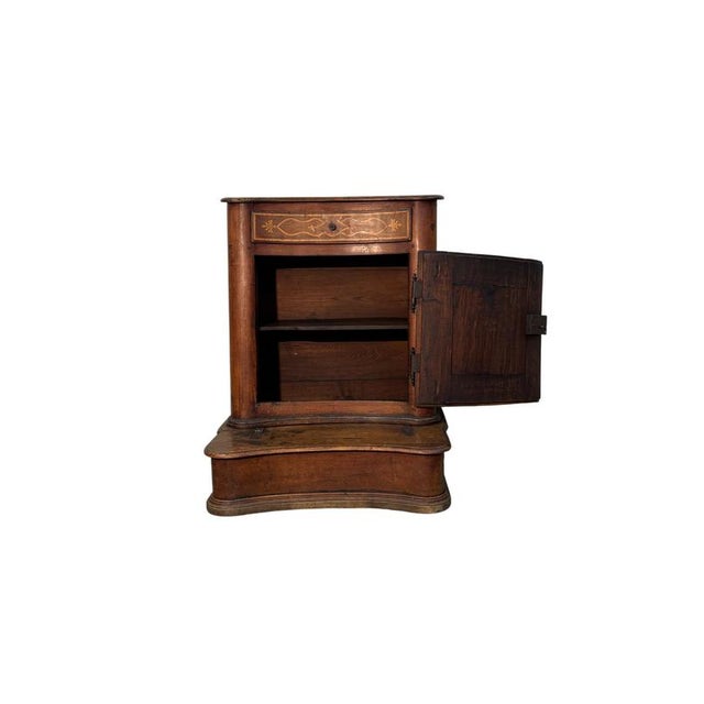 Antique walnut kneeler dating back to the 19th century, characterized by a compact structure and decorative workmanship...