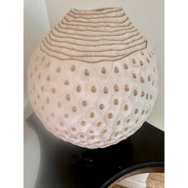 A sculptural hand-built stoneware vase by ceramic artist Larry Halvorsen, signed and dated “Halvorsen 90.” The rounded...