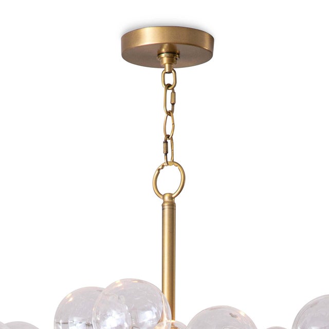 Light and airy, the Bubbles chandelier radiates light through a cluster of hand blown glass globes. The tiered metal frame...