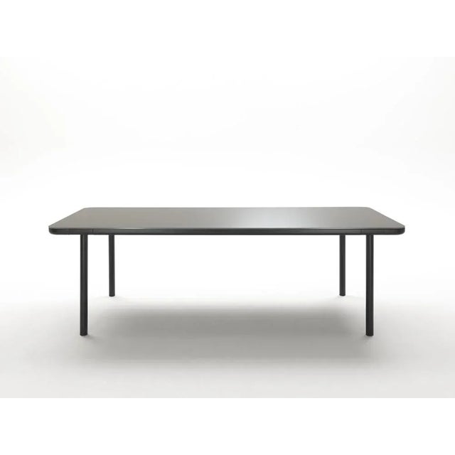 Lacquered point neuf table by rodolfo dordoni materials: black metal base with lacquered glass top resting on a black...