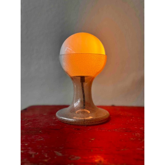A masterpiece of 1970s italian lighting design, this lt215 table lamp by carlo nason for mazzega is a stunning example of...
