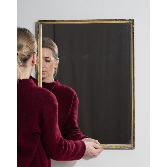 A mirror whose dark wood frame with gilt inner edge gives it real character at first glance. The piece dates to 1900s,...