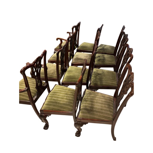 An impressive set of twelve Chippendale-style dining chairs crafted in richly finished mahogany, including two armchairs...