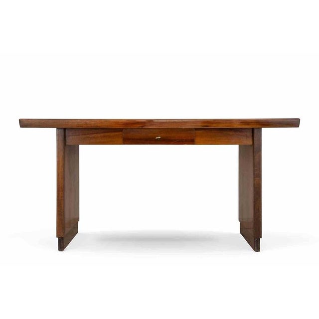 Midcentury Writing desk realized by Mobili Castelli, Italy. Walnut veneer, brass key, single drawer. A refined example of...