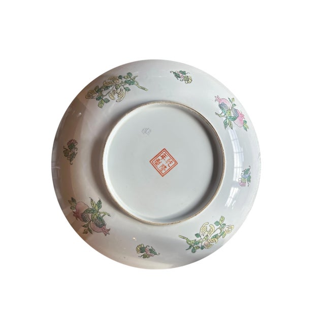 Beautiful vintage Chinese porcelain decorative plate featuring an elaborate famille rose-style design with a central...