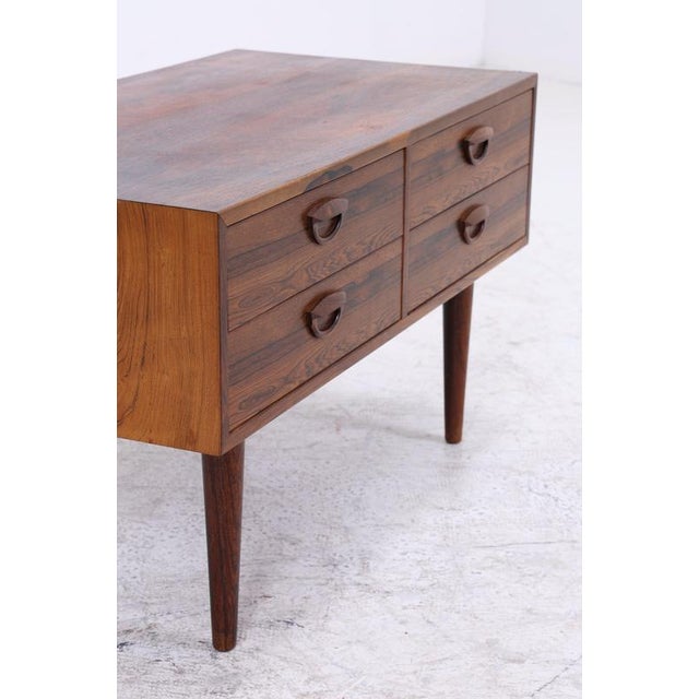 Vintage rosewood chest of drawers by Kai Kristiansen from the 1960s. The striking grain, characteristic handles, and...