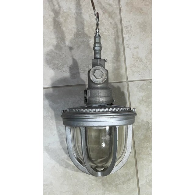 Mid-century aluminum industrial or nautical chandelier, the pendant's modest size makes it perfect in most any space. The...