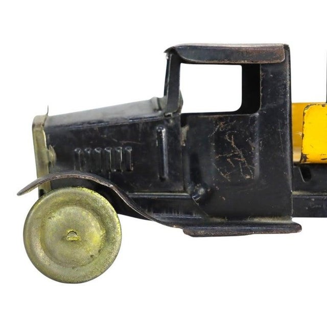 An antique pressed steel toy truck manufactured by Metalcraft, St. Louis, dating to approximately 1920. This advertising...