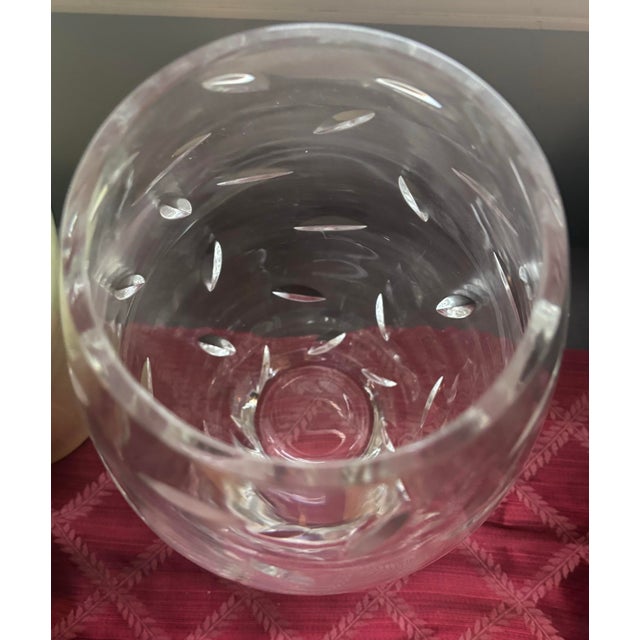 A stunning and substantial Tiffany & Co. hand-cut crystal vase featuring an elegant all-over leaf motif, beautifully...