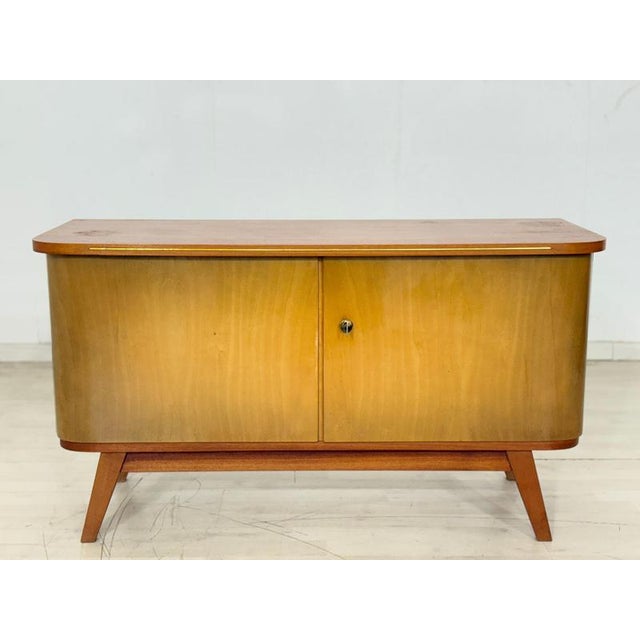 Stylish mid-century modern chest of drawers from the 1960s. The chest is distinguished by its beautiful walnut and birch...