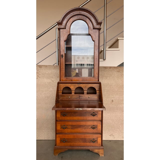 This is a charming George l style walnut diminutive secretary. The domed cornice over a conforming vitrine cabinet . The...
