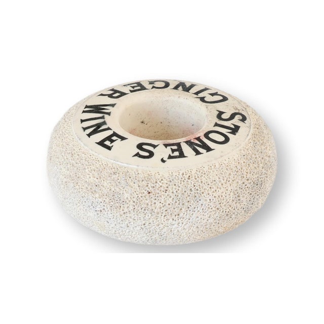 Antique Stone’s Ginger Wine advertising match striker, early 20th century, featuring bold black typography encircling the...