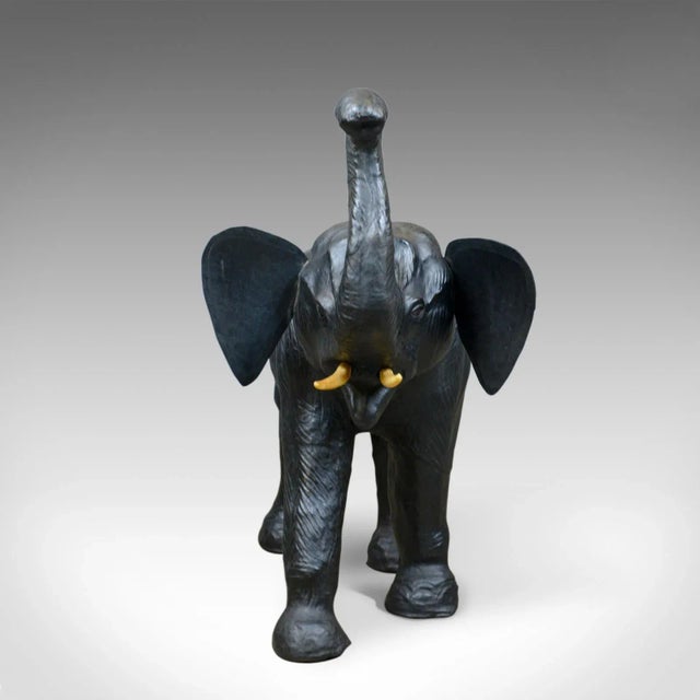 This is a large, vintage leather elephant sculpture. A three foot tall, at trunk (72cm to back) striding elephant model...