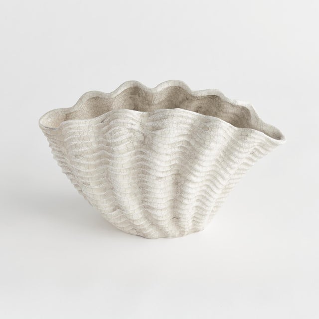 With an antique subtle crackle glaze, this generously scaled shell vase is a stunning accent. Whether on a side table,...