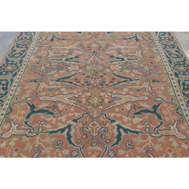 Hand-knotted in wool, this 7x10 vintage European rug is a sophisticated example of mid-century interpretations of...