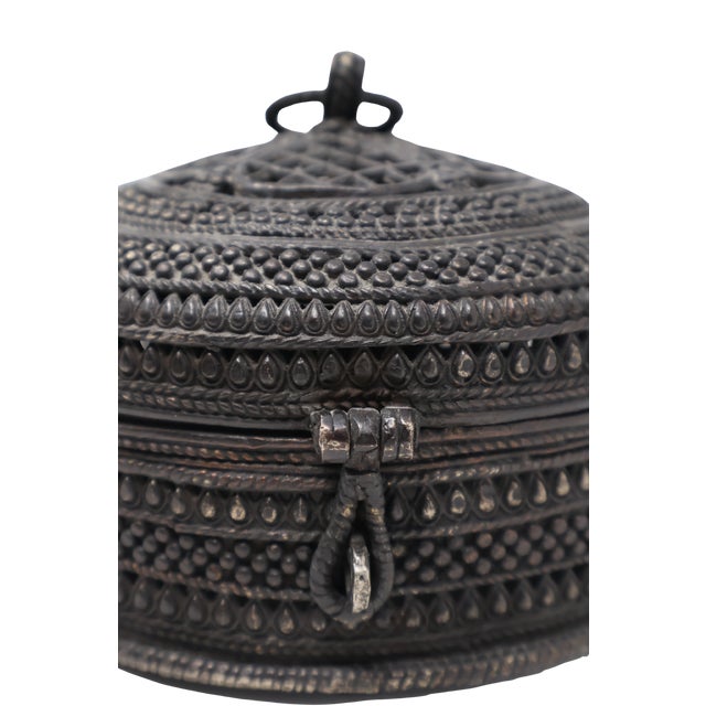 Intricate metalwork gives this substantial cast-brass basket-form box its distinctive presence. A domed lid with pierced...