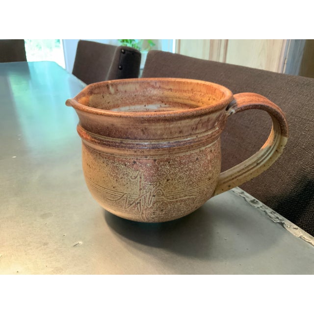 This ochre Chris Davis medium functional pottery pitcher is from an estate in Ohio. It was most likely purchased between...