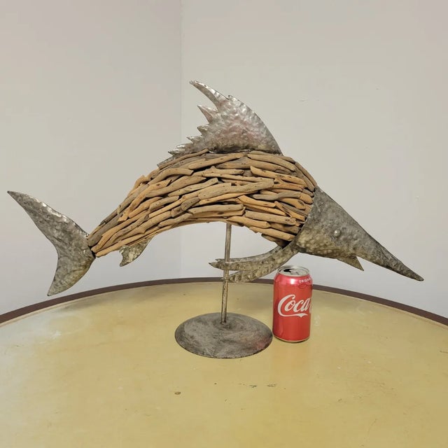 Celebrate coastal style with this striking driftwood and hammered metal fish sculpture. Modeled after a marlin or...