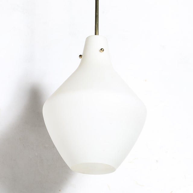 This pair of Mid-Century Modernist Murano glass pendant chandeliers, crafted in Italy circa 1960, embodies the exquisite...