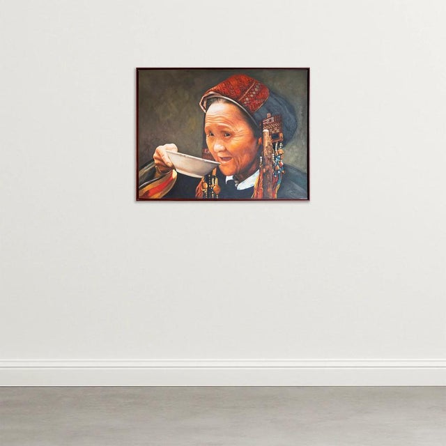 This exquisite oil on canvas from 1998 captures the timeless grace of an elder tribal woman, immersed in a quiet moment as...