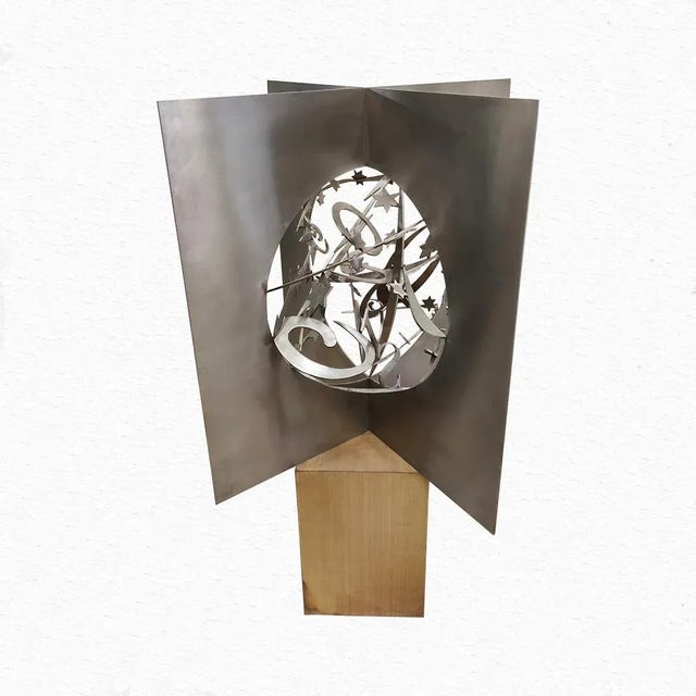Angelo Rinaldi, ''Galaxy'' sculpture in hand polished steel, assembled with geometric elements, h. cm. 80x80x80,, signed...