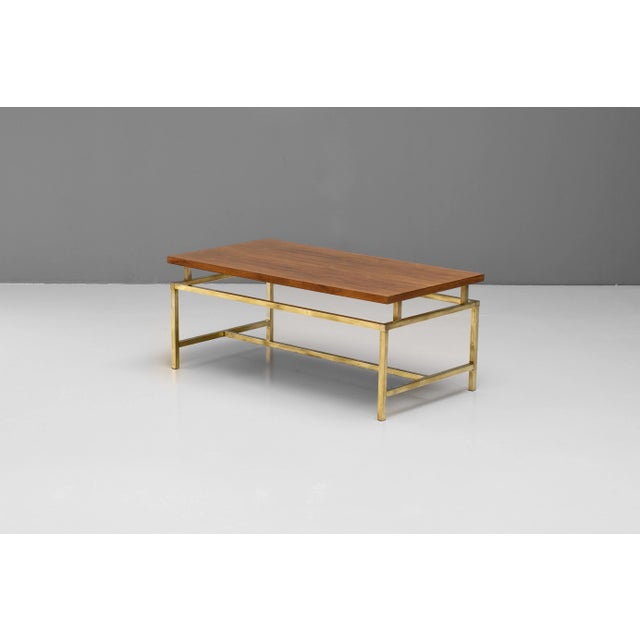 Mid-century coffee table by M.A.S with a solid teak top and polished brass base. U.K circa 1960.
