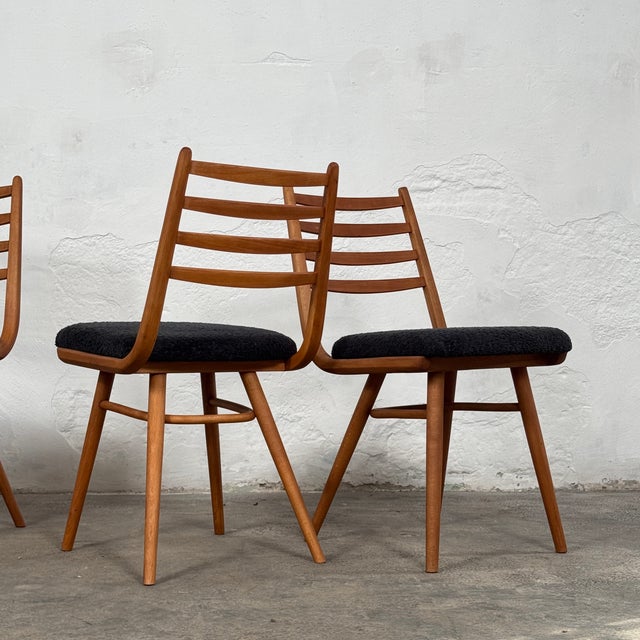 This set of four dining chairs is a quintessential example of czechoslovakian mid-century modern design. Designed by the...