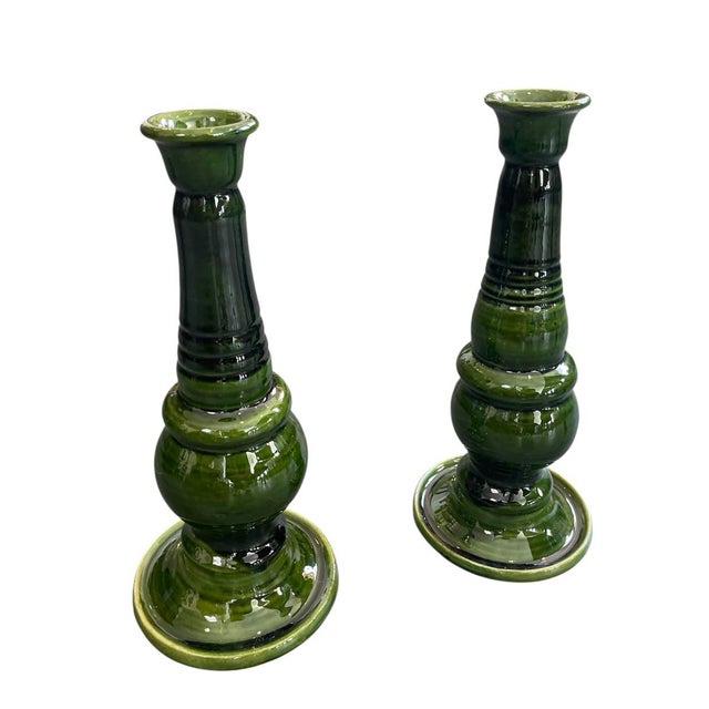 A striking pair of handcrafted ceramic candlesticks originating from Morocco. These tall, elegant pillars feature a rich,...