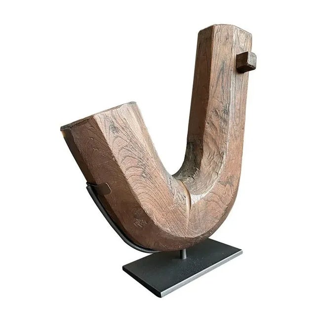 A Japanese kettle hook from the Edo period carved of Zelkova wood. The jizagaki is the hook from which an iron kettle for...