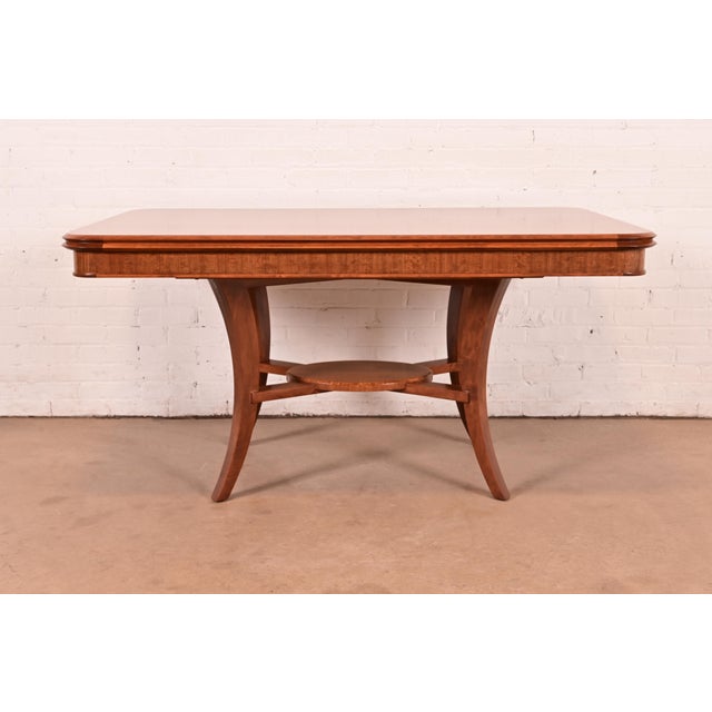 A gorgeous modern Art Deco walnut and burl wood dining table, breakfast table, center table, or library table By John...
