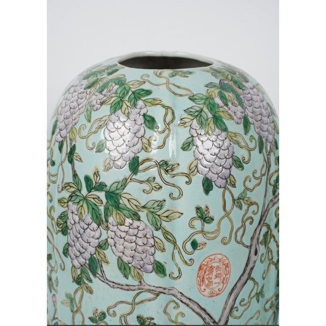 A beautifully executed pair of Chinese porcelain vases featuring a soft celadon ground richly decorated with cascading...