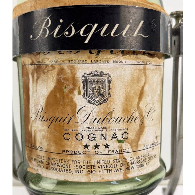 A striking piece of French cognac history, this large-format Bisquit Dubouché bottle pairs green glass and richly detailed...