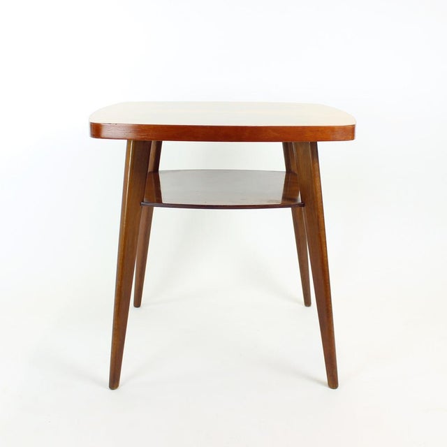 Beautiful tall coffee table (64 cm) in a classic mid-century design. The square form is subtly softened by gently curved...