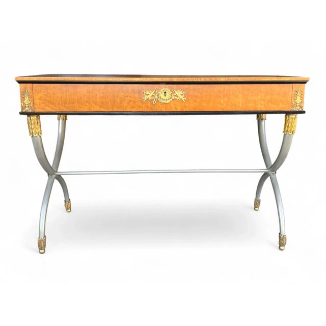 This elegant vintage writing desk reflects the timeless sophistication of French Empire and neoclassical design. Crafted...