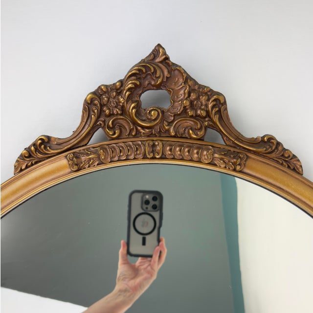 A beautiful vintage Louis Bierfeld American Beauty mirror, featuring a large round profile with ornate gesso flourishes....