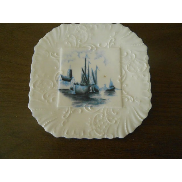 This marvelous vintage plate is created in gorgeous blue and white glazed earthenware with a delightful European harbor...