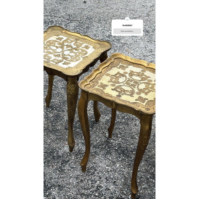 Elegant pair of vintage Italian Florentine-style accent tables featuring beautifully carved giltwood frames, gracefully...