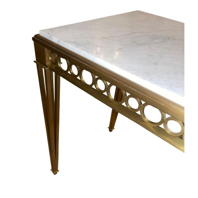 Elegant Neoclassical-style console table Atributed to Paul M. Jones, crafted in high-quality bronze and topped with a...