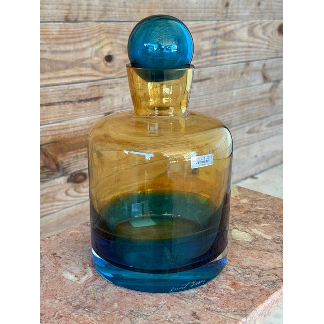 Striking vintage Waterford art glass decanter designed by Gerard Treacy, featuring a bold blue-to-amber ombré body with a...
