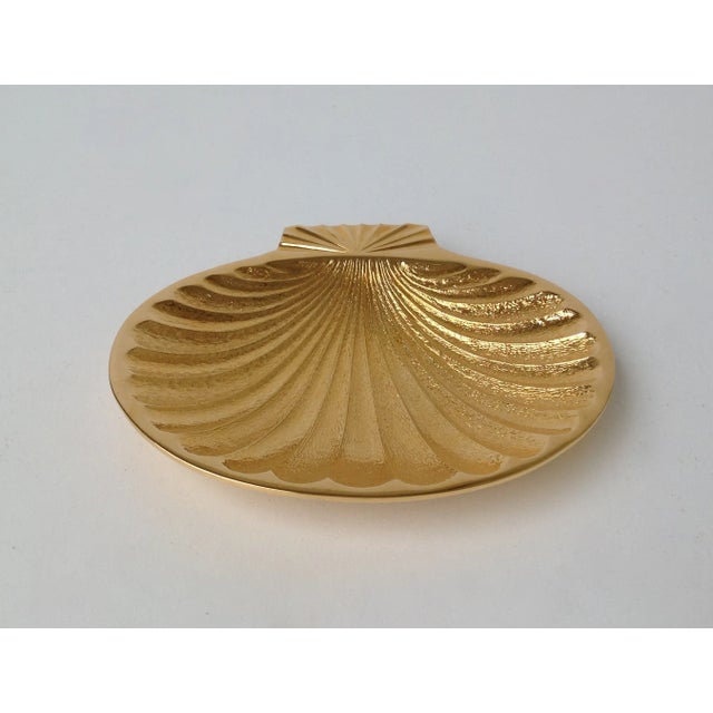 C.1980's; solid gold plate over copper fanned shell-shaped trinket or ring dish with interior textural finish. The...