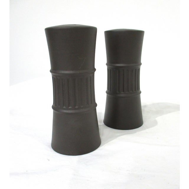 A pair of Dansk salt and pepper shakers from their Flamestone collection having ribbed designs and a mat finish to the...