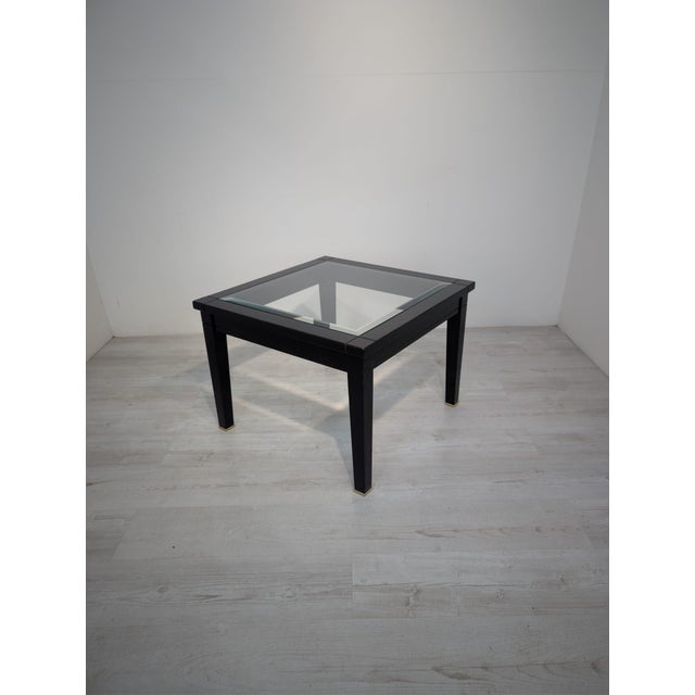 A unique coffee table with a timeless, elegant design, crafted from solid wood and finished in deep black. This piece...