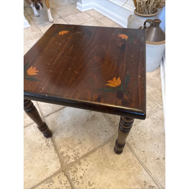 Charming vintage Kling Furniture end table featuring hand-painted folk art floral accents on a rich, dark wood top. This...