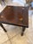 Charming vintage Kling Furniture end table featuring hand-painted folk art floral accents on a rich, dark wood top. This...
