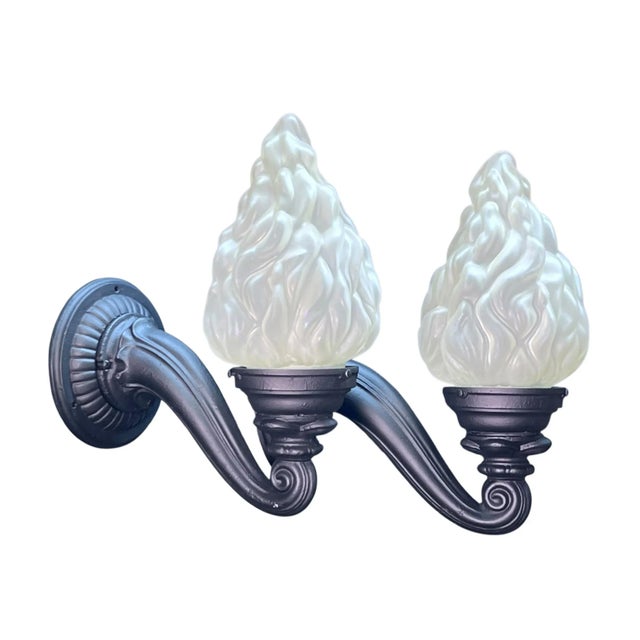 Curved arm sconces in cast iron have new black paint and electrical. Shades are vintage, not the modern equivalent you...