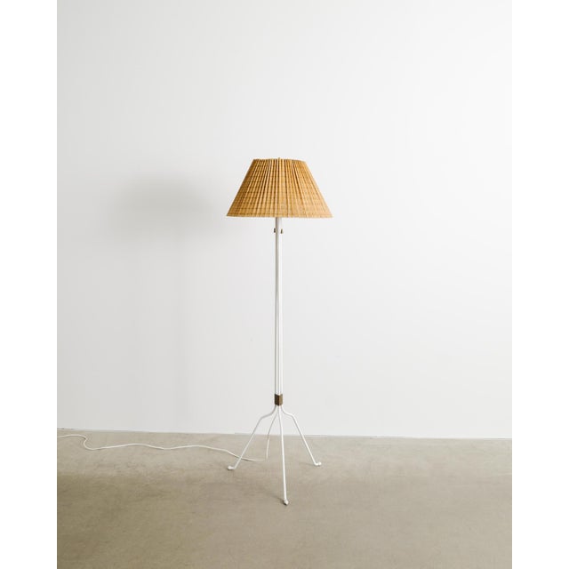 A rare and iconic Finnish mid century "30-058" floor lamp in white lacquered metal with a decorative and well matching...