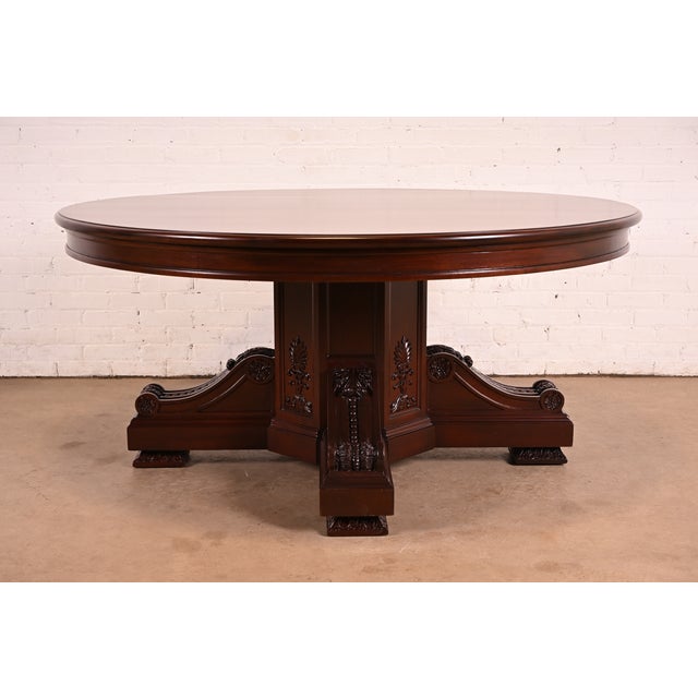 An outstanding antique Victorian or Renaissance Revivial carved mahogany pedestal dining table In the manner of R. J....